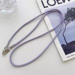 Stylishly designed necklace that attaches to the phone, with a plastic part to secure it to the phone